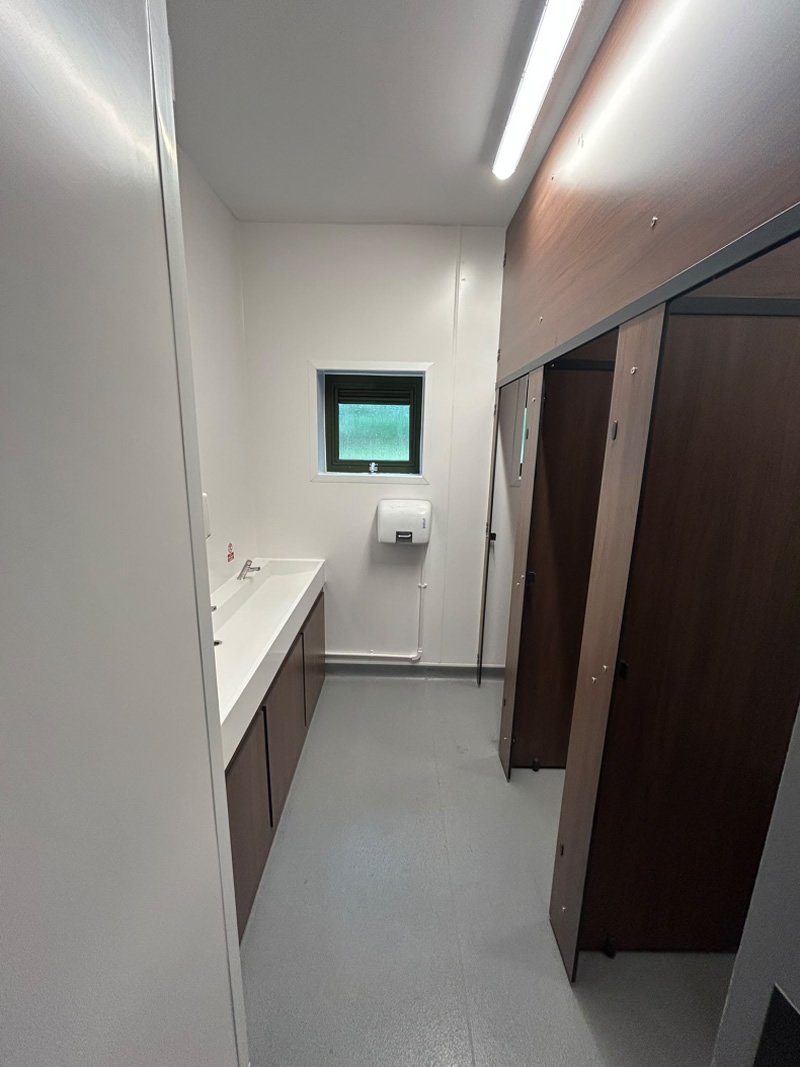 The refurbished washroom, with new trough basin and toilet cubicles